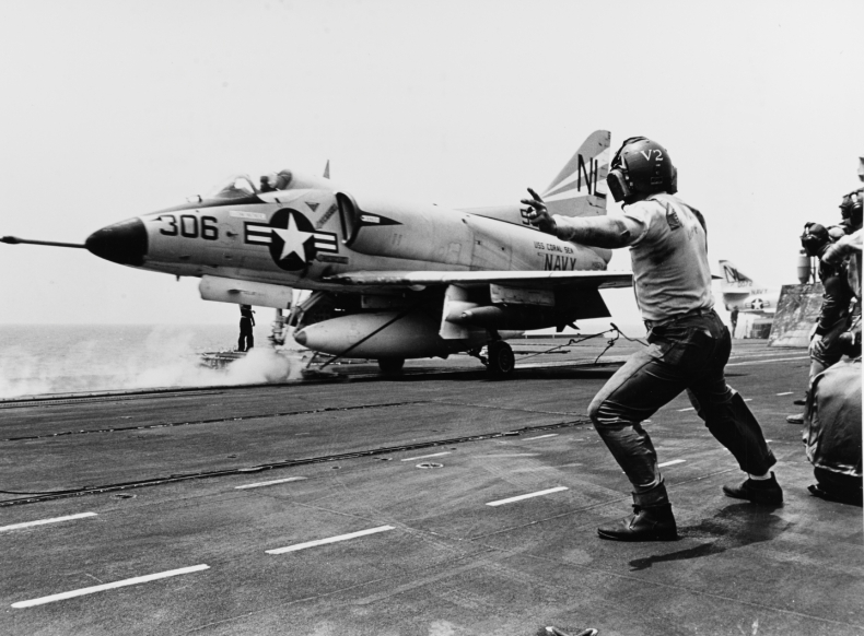 Vintage image of Navy aircraft launching from aircraft carrier