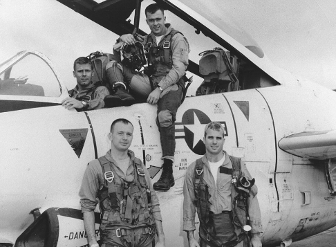 Vintage image of John McCain and others in front of Navy aircraft